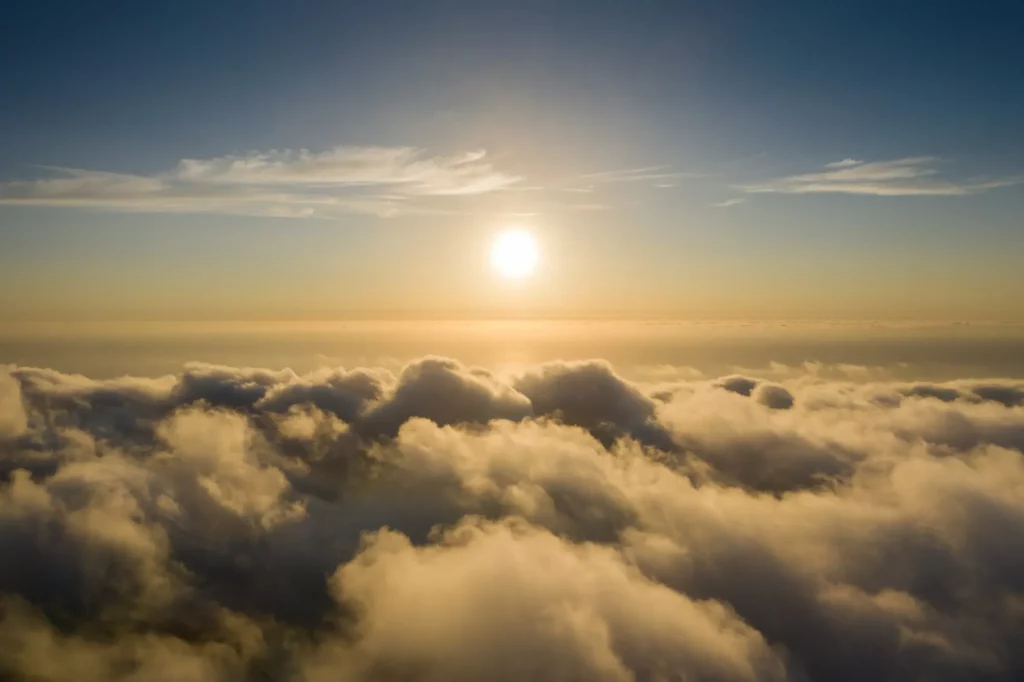 Mer de nuages au lever du soleil vue du ciel, horizon doré.